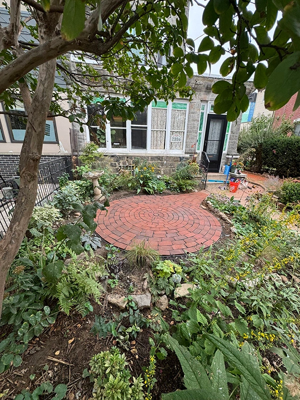 Land art comes to Fishtown! Custom-designed circular patio using 53DD bricks that balance blended reds and warm earth tones. It's hardscaping outside the box -- custom brickwork as living art.