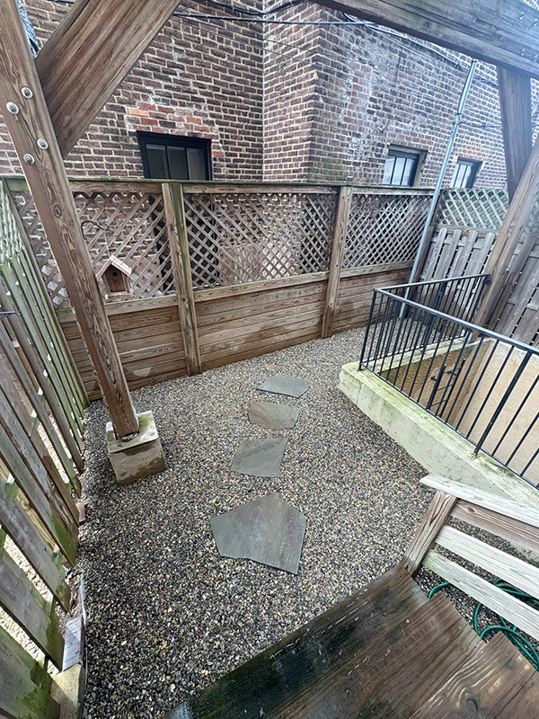 Fishtown townhouse rejuvinates its backyard with minimal river jack and full-color irregular bluestone slabs.