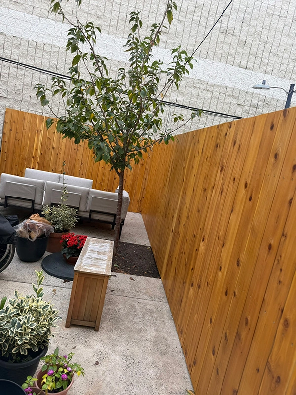 Queen Village kiln-dried knotty western red cedar fence boards; went with a vertical install with this one.