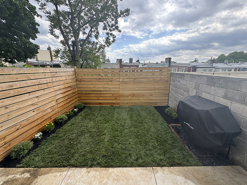 Hilly and noble, this Art Museum area backyard goes from rubble to verdant splendor.