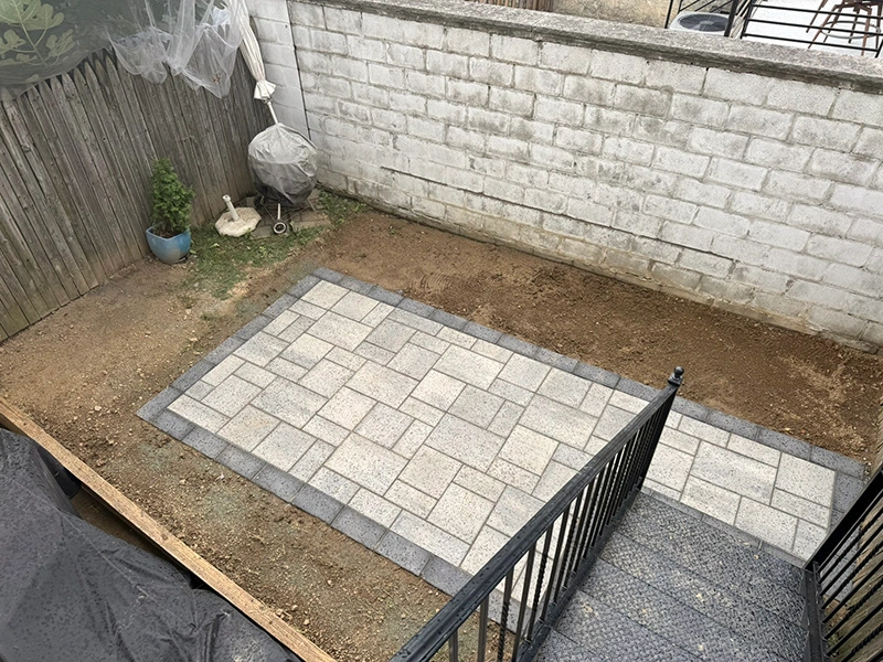 Fishtown new Techo Bloc patio - Blu 60 Smooth slabs with an Onyx Black sailor course border.